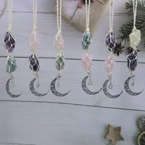 Handmade raw crystal hanging pendant detail featuring woven macrame, natural stones and moon.