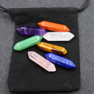 Detail shot of colorful double terminated crystal pillars set on black pouch, crystal decor.