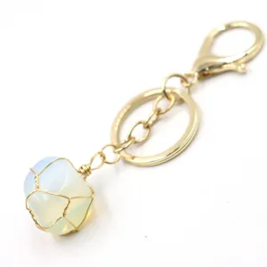 Wire-wrapped crystal stone keychain detail showing exquisite gold hardware and pendant.