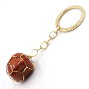 Detail shot of natural stone wire-wrapped keychain with gold metal ring and chain.