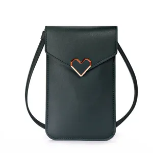 Dark green mini phone crossbody bag detail, geometric heart metal buckle, PU leather.