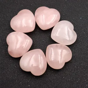 Rose quartz crystal heart stone detail shot, polished healing palm stone craft decor.