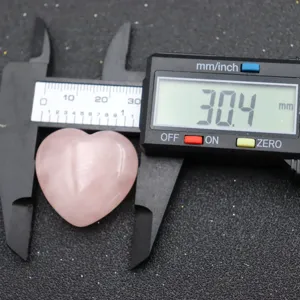 Natural rose quartz crystal heart gemstone for yoga and meditation, polished healing stone.