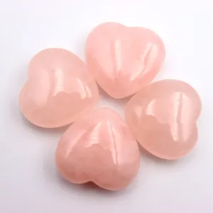 Natural rose quartz heart crystal pocket stone palm stone meditation reiki healing gemstone detail view.