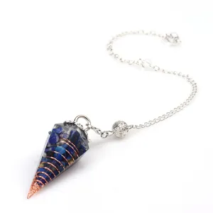 Detailed view of crystal dowsing pendulum with blue stone chips and copper wire wrapping.