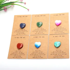 Detail shot of heart-shaped crystal pocket hug stones on kraft paper greeting cards for gifts.