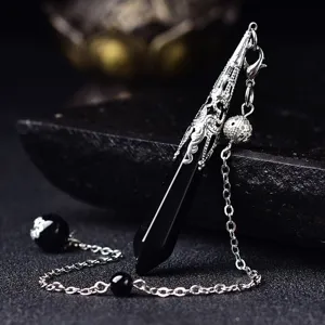Natural black stone dowsing pendulum necklace with intricate silver metal cap and chain.
