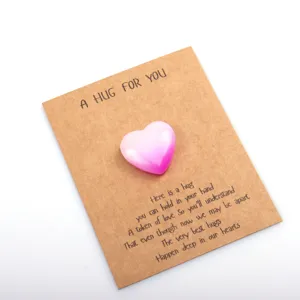 Detail shot of a gradient pink heart crystal stone attached to a greeting card for gift.