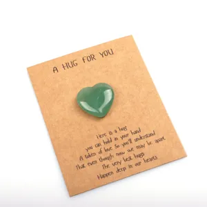 Detailed shot of a green crystal heart stone on a hug card, perfect for romantic gifts.