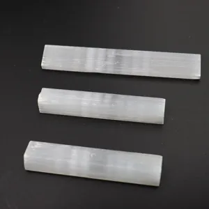 Natural white selenite crystal wand detail shot, raw gypsum mineral stone close-up display.
