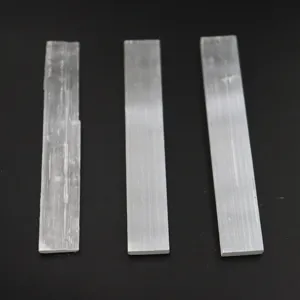 Natural white selenite crystal sticks raw mineral specimens detail view showing texture.