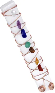 Close up detail of natural healing selenite crystal wand wrapped with colorful chakra stones.