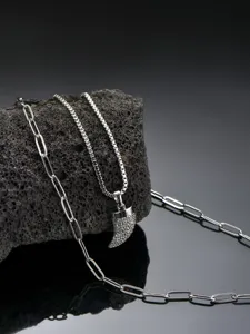 Detailed shot of double-layer stainless steel men's necklace with paved cubic zirconia horn pendant.