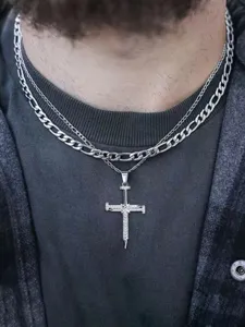 Stainless steel layered cross necklace with nail pendant and figaro chain detail shot.