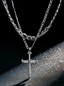 Stainless steel double layer necklace with nail cross pendant and figaro chain details.