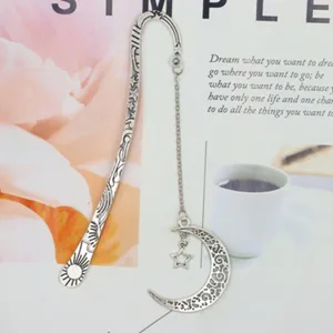 Vintage metal bookmark with moon star pendant and chain for reading lovers and students.