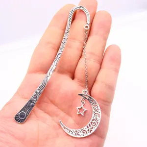 Vintage metal bookmark with moon star pendant, creative hollow reading accessory.