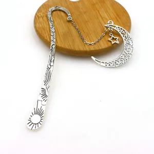 Vintage metal bookmark with hollow moon star pendant creative retro reading page marker.