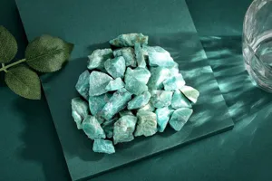 Natural green aventurine rough crystal stones detail shot, perfect for decoration and crafts.