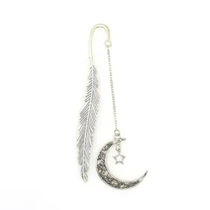 Metal feather bookmark detail showcasing the vintage crescent moon and hanging star pendant design.