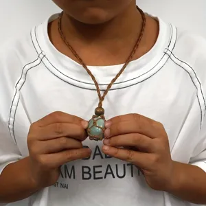 Detail shot of the adjustable braided net pocket crystal necklace showcasing the raw stone pendant.