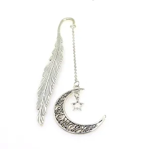 Vintage metal feather bookmark with hollow moon pendant, elegant gift for book readers.