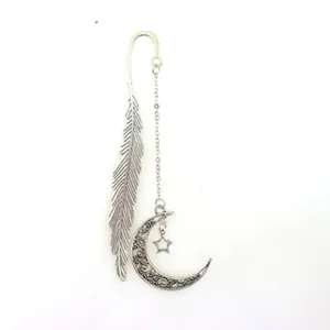 Metal bookmark detail view featuring feather hook and hollow crescent moon pendant style.
