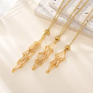 Golden metal geometric mesh cage pendant necklace with elegant bamboo link chains for women.
