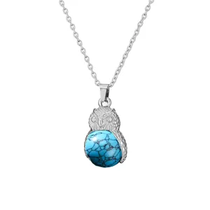 Blue stone owl pendant necklace detail close up view, silver chain jewelry accessory.