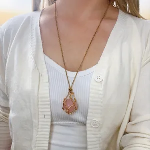 Detailed view of natural rose quartz crystal stone wire cage metal chain pendant necklace.