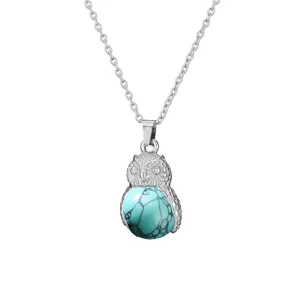 Detailed view of silver owl pendant necklace featuring a turquoise stone and delicate chain.