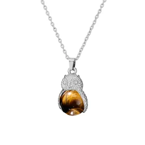 Silver-tone owl pendant necklace featuring a natural tiger eye gemstone sphere detail.