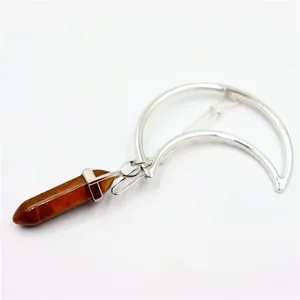Detail view of the silver crescent moon hairpin featuring a hanging brown crystal hexagonal pillar charm.