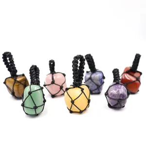 Detailed close-up view of various natural crystal gemstone pendants in black woven nets.