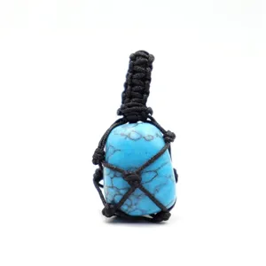 Close up view of the handmade black rope woven blue turquoise stone crystal pendant.
