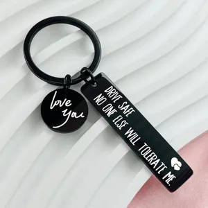 Stainless steel keychain set featuring engraved loving messages, durable metal design for daily use.