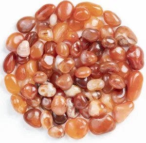 Close-up detail of polished natural red carnelian tumbled stones for decoration use.