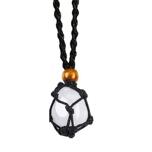 Crystal raw stone pendant detail view, black woven net pocket necklace, adjustable cord.