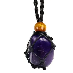 Close-up detail of a raw amethyst crystal gemstone secured in a black woven mesh cord necklace.