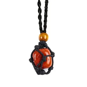 Detailed close-up view of the raw red stone pendant wrapped in a black woven net cord.