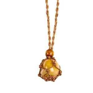 Detailed view of hand-woven brown rope net bag necklace featuring natural yellow crystal rough stone.