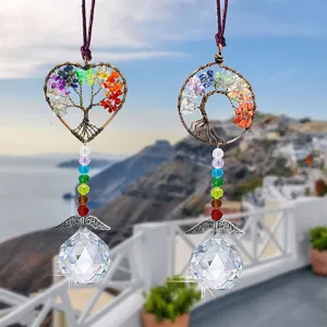 Close-up detail of hanging crystal suncatcher tree of life with colorful chakra stones.