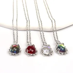 Detailed view of bohemian leaf vine moonstone necklaces featuring colorful crystal orb pendants.