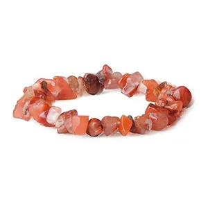 Natural carnelian chip gemstone bracelet detail shot, irregular crystal quartz stretch jewelry piece.