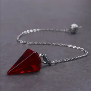 Roter Kristall facettierter Pendelanhänger Detail Nahaufnahme mit sechseckiger Spitze und Kette.
