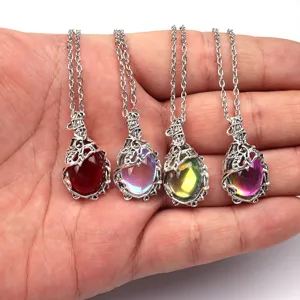 Detailed view of retro bohemian leaf vine metal gemstone pendant necklaces in hand.