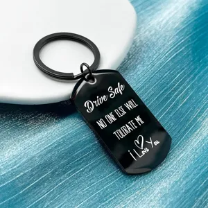 Stainless steel black engraved keychain detail view showing Drive safe text and romantic quote.