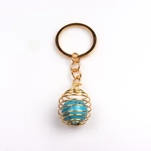 Goldener Metallschlüsselanhänger mit Spiralanhänger und blauem Schmuckstein Perle 16mm
