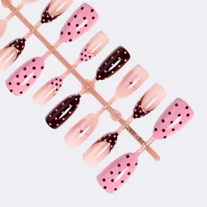 Detailed view of 30pcs press-on nails set with french tips, polka dots and cute floral designs.
