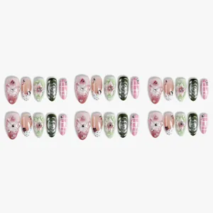 Almond press-on nails set with 3D floral, silver swirls, rhinestones, and cute plaid design.